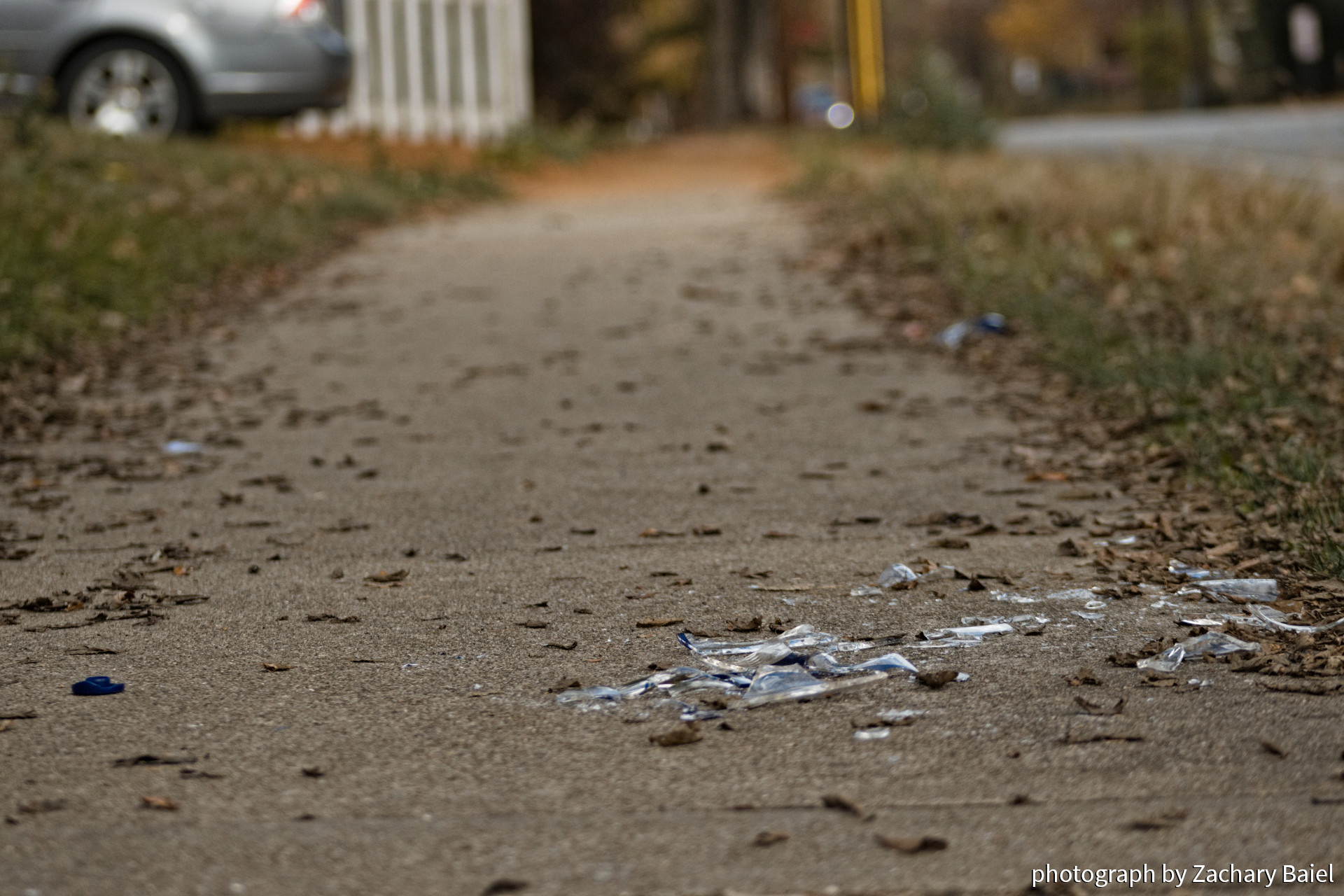 Smashed alcohol bottle on the sidewalk near Stadium and Salisbury Street | West Lafayette, Indiana | November 2022