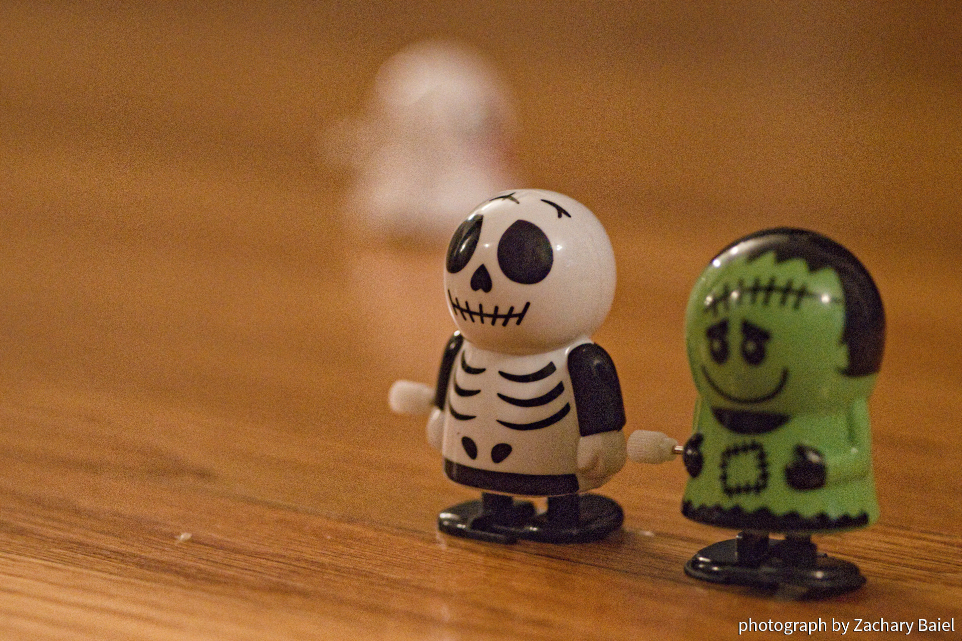 Skeleton and Frankenstein's Monster wind-up toys on a hardwood floor | November 2022